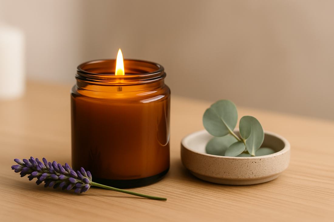 Amber glass candle with lavender and eucalyptus on a wooden surface.