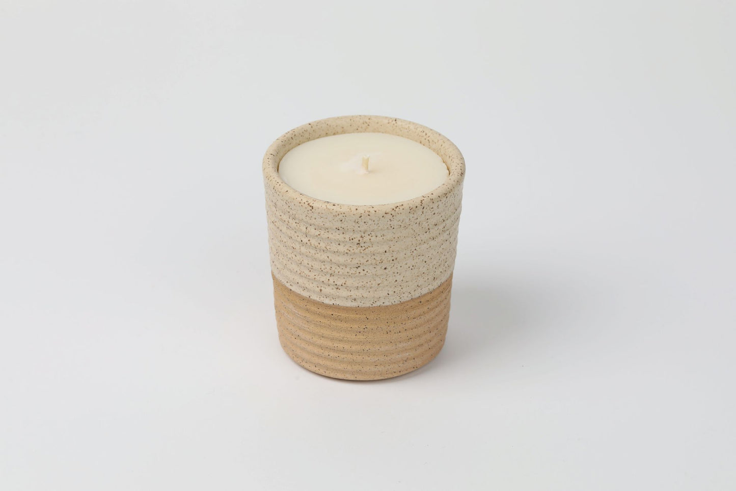 ReCandle Co. refillable candle in a walnut colored ceramic candle vessel with the 100% soy wax refill in the vessel.