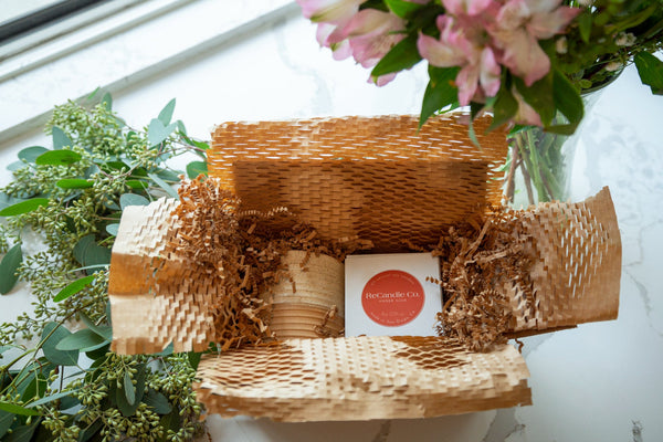 A candle subscription in a packaging box