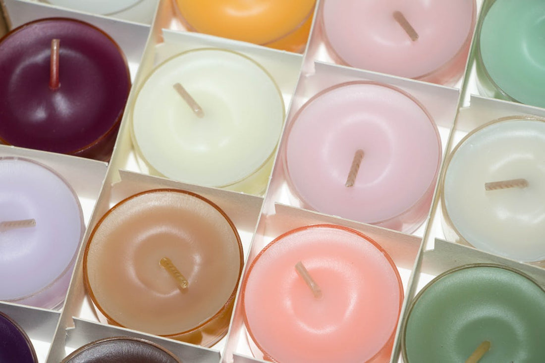 Colorful non-toxic candles in glass holders.