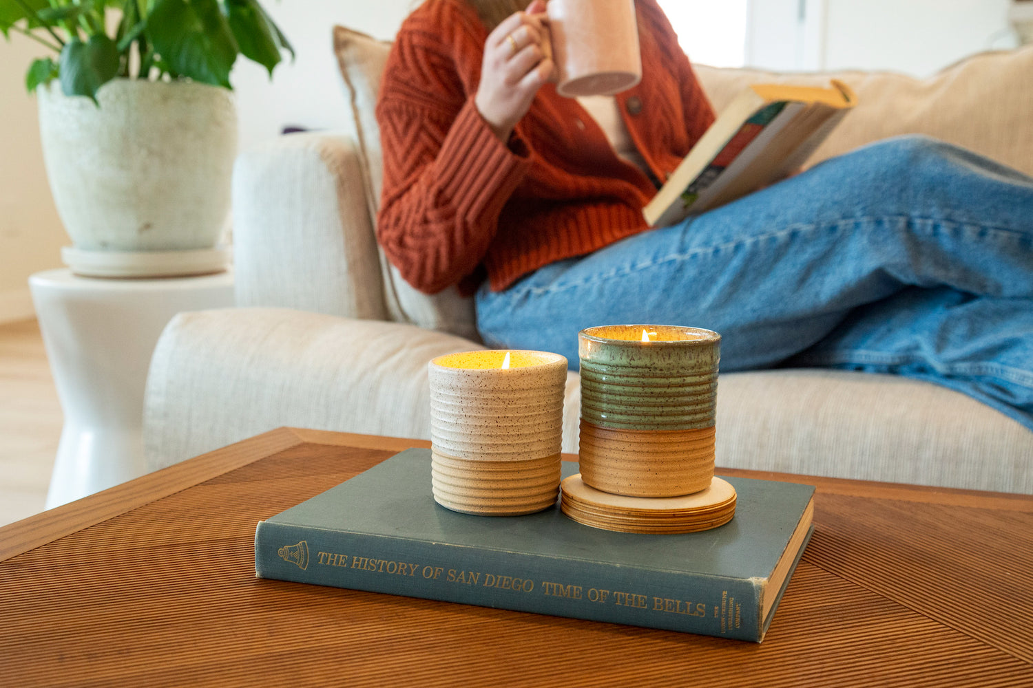 Two reusable candle jars side by side on a coffee table