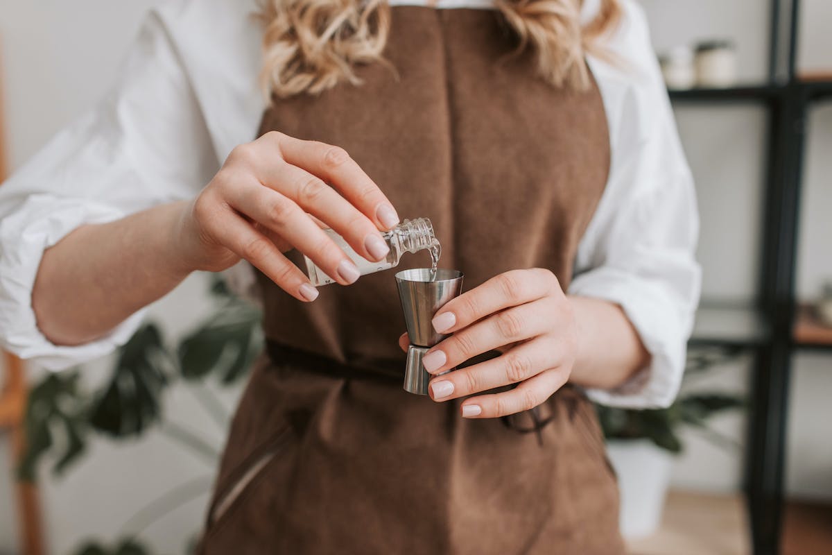 Fragrance oil being measured out for candle making