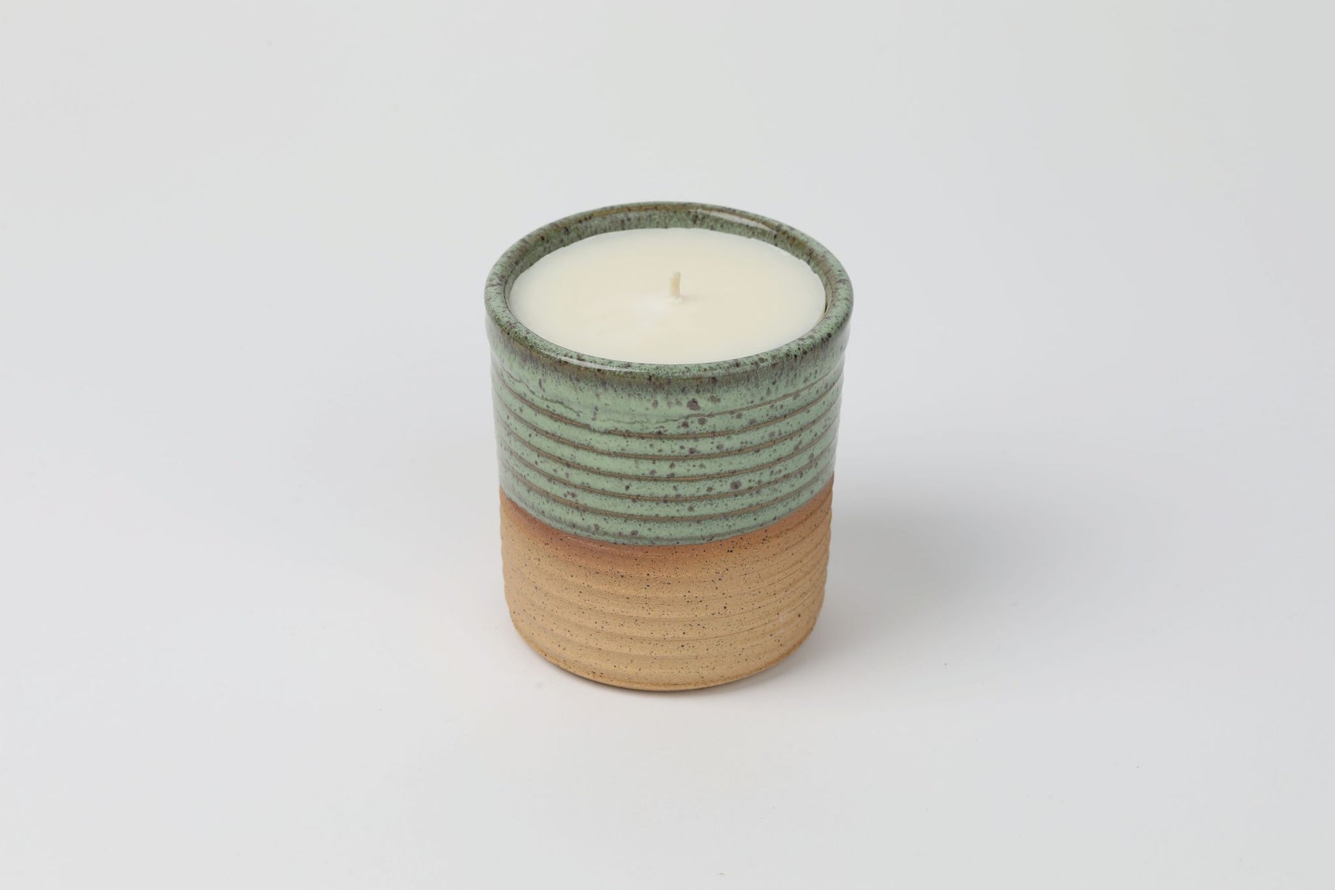 ReCandle Co. refillable candle in a teal ceramic candle vessel