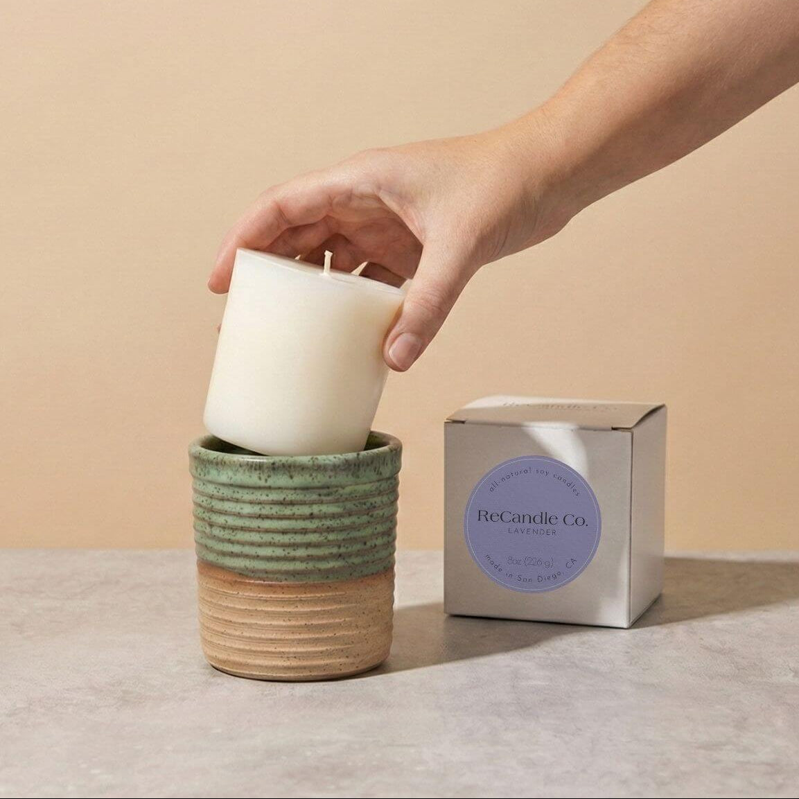 Inserting Lavender candle refill into sustainable teal ceramic refillable candle jar