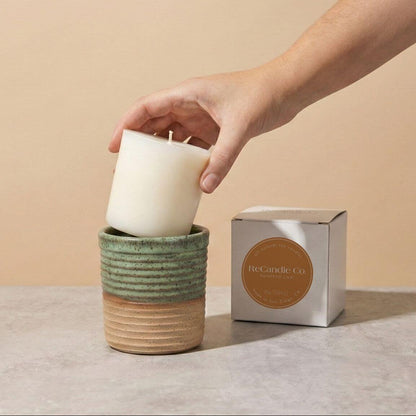 Inserting Pumpkin Chai candle refill into sustainable teal ceramic refillable candle jar